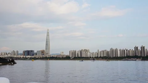 Slow motion of Lotte Tower reflection on river during daylight Stock Footage 314519338