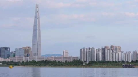 Slow motion of Lotte Tower skyline seen from across Han River in Seoul Stock Footage 314740091