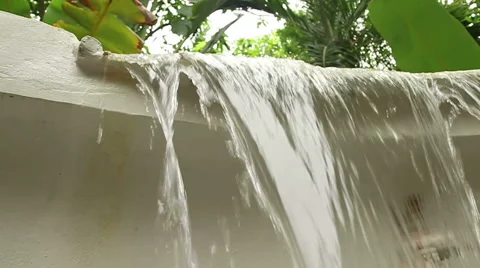 Slow motion low angle of lip of manmade waterfall. Video stock 56303363