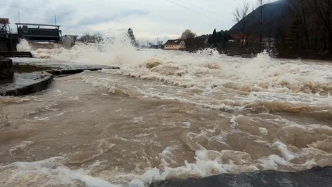 Slow motion low angle raging brown flooded water in Sava river Stock Footage 121929475