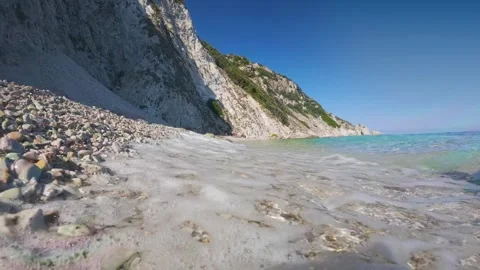 Slow motion low angle shot of small waves on Spiaggia di Sansone beach, Elb.. Stock Footage 318968544
