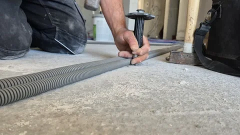 Slow Motion Low Angle Shot of Fixing Concrete Nail in Ceiling 動画素材 340643678