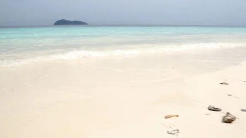 Slow motion Low angle view of white sand beach and blue chrystal clear  Stock Footage 87737924