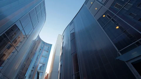 Slow motion. Low Angle. Walk along the corporate campus, town from high glass Stock Footage 87844952