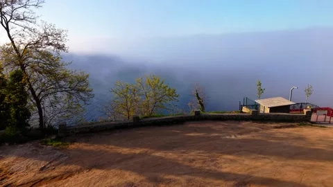 Slow Motion Low-Level Flight Over a Foggy Coast at Sunset Stock Footage 341808438