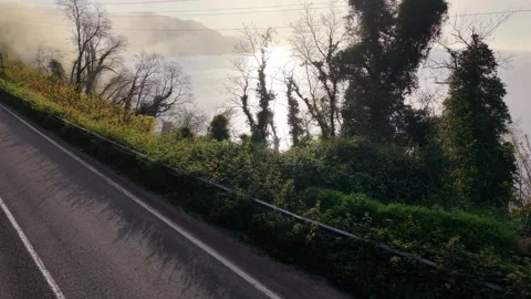 Slow Motion Low-Level Rise Above a Foggy Coast at Sunset Stock Footage 341816109