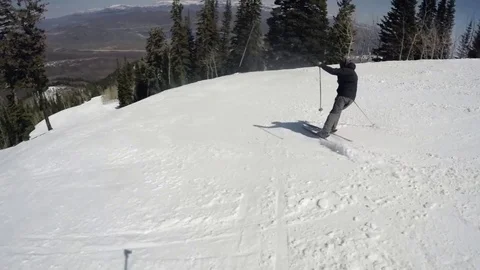 Slow motion a low shot of a man crashing at ski resort Stock Footage 74387439