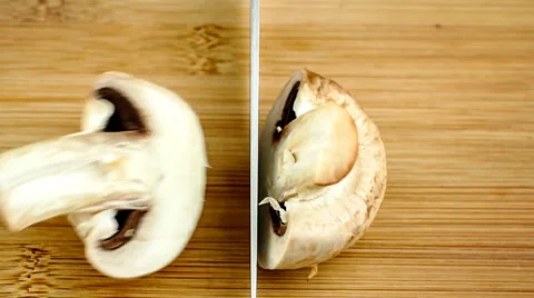 Slow motion macro of chopping ripe mushroom in half Stock Footage 47003016