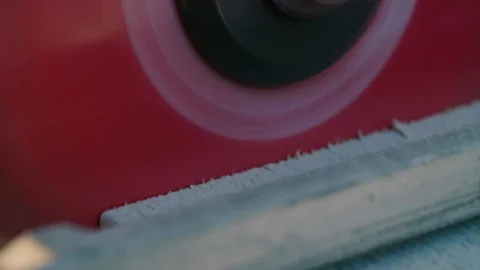 Slow motion Macro: Circular Power-Saw finishes cutting through a wooden plank Stock Footage 92502332