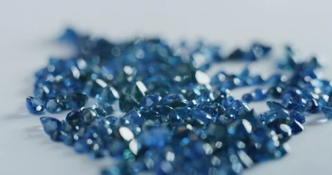 Slow motion macro of goldsmith sorting high quality blue diamonds. Video stock 114942473