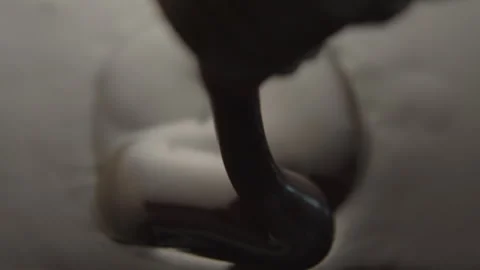 Slow Motion Macro of Liquid Chocolate Drop - Mesmerizing Tabletop Footage Stock Footage 276870293