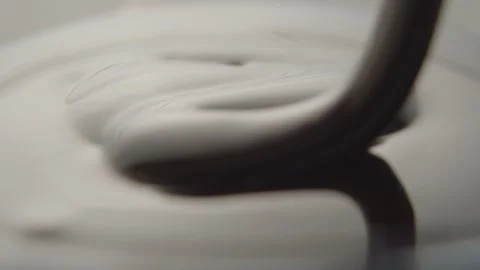 Slow Motion Macro of Liquid Chocolate Drop - Mesmerizing Tabletop Footage Stock Footage 276870298