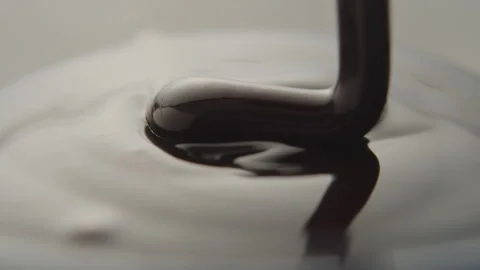 Slow Motion Macro of Liquid Chocolate Drop - Mesmerizing Tabletop Footage Stock Footage 276870511