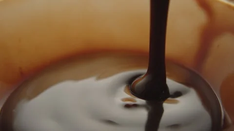 Slow Motion Macro of Liquid Chocolate Drop - Mesmerizing Tabletop Footage Stock Footage 276870597