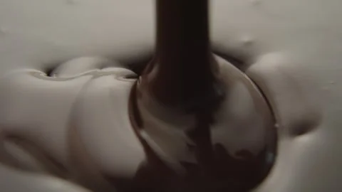 Slow Motion Macro of Liquid Chocolate Drop - Mesmerizing Tabletop Footage Stock Footage 276871249