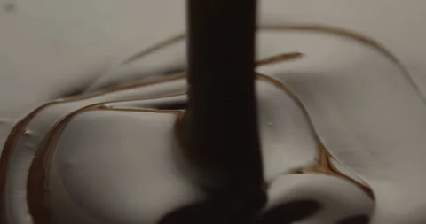 Slow Motion Macro of Liquid Chocolate Drop - Mesmerizing Tabletop Footage Stock Footage 276874911