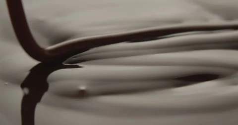 Slow Motion Macro of Liquid Chocolate Drop - Mesmerizing Tabletop Footage Stock Footage 276874943
