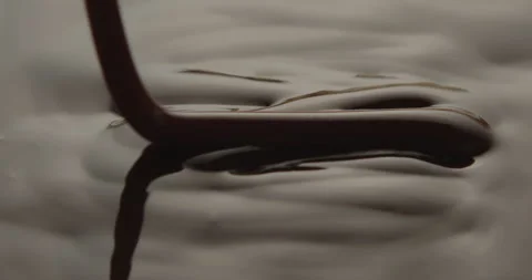 Slow Motion Macro of Liquid Chocolate Drop - Mesmerizing Tabletop Footage Stock Footage 276875048