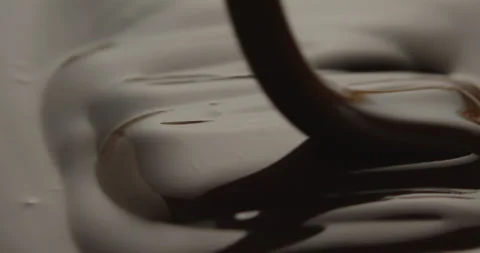 Slow Motion Macro of Liquid Chocolate Drop - Mesmerizing Tabletop Footage Stock Footage 276875066
