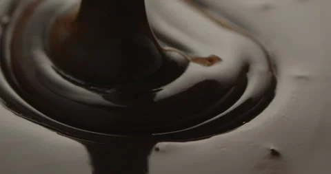Slow Motion Macro of Liquid Chocolate Drop - Mesmerizing Tabletop Footage Stock Footage 276875101