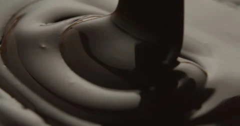 Slow Motion Macro of Liquid Chocolate Drop - Mesmerizing Tabletop Footage Stock Footage 276875111