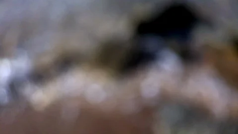 Slow motion macro ocean tide coming in sparkling Stock Footage 100601018