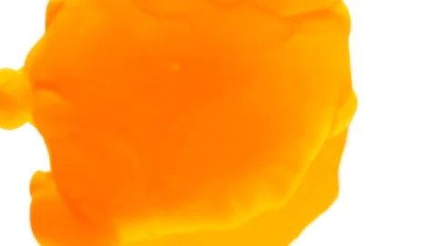 Slow motion of macro orange color ink exploding in water creating abstract sh Stock Footage 79780579