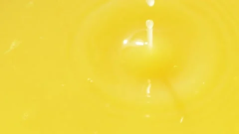Slow motion of macro orange droplet falling down into fresh orange juice drink Stock Footage 141784769