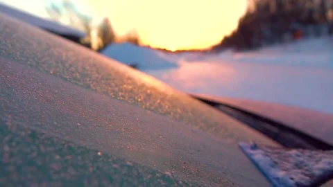 SLOW MOTION MACRO: Person removing frosty snowflakes off a frozen car window Stock Footage 80924818