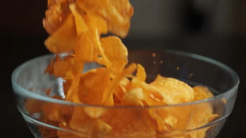 Slow Motion Macro Shot of Chips Falling Down Into Glass Bowl. Close-up Pota.. Stock Footage 327597686
