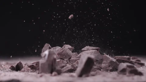 Slow motion, macro shot: Chocolate pieces falling. UHD25p Stock Footage 249589383