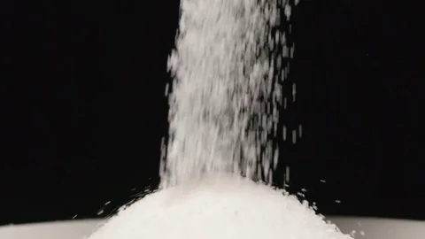 SLOW MOTION: Macro shot of falling of salt on a heap in a dish Stock Footage 71451715