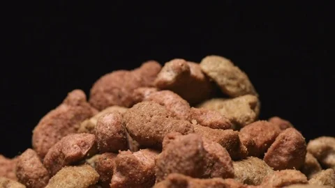 SLOW MOTION: Macro shot of falling of pet food on a heap Stock Footage 71451757