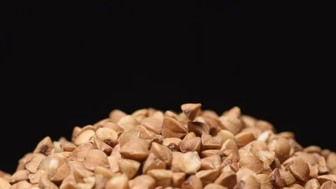 SLOW MOTION: Macro shot of falling of buckwheat on a heap Stock Footage 71451908