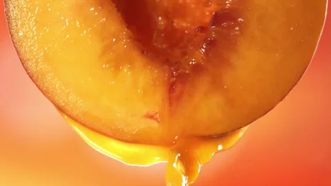 Slow Motion Macro Shot of Flowing Peach Juice from Half Peach Stock Footage 161698895