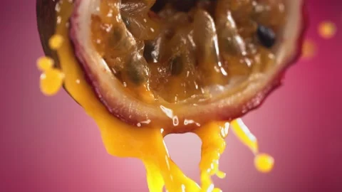 Slow Motion Macro Shot of Flowing Passion Fruit Maracuya Juice from Halved Stock Footage 193096470