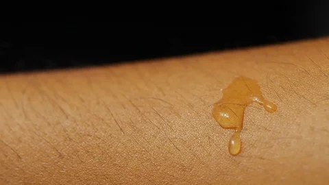 Slow motion macro shot of fresh cleansing water drop on human skin Stock Footage 113594257