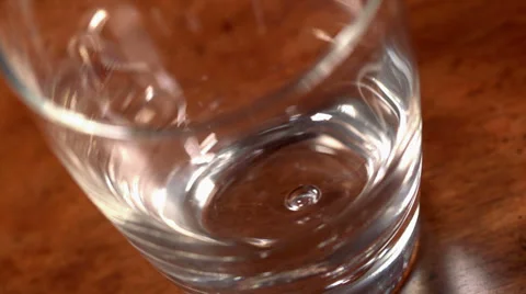 Slow motion macro shot of ice cubes falling into a cocktail glass 動画素材 34655824