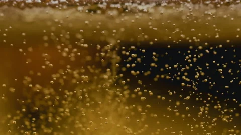 Slow motion macro shot of lager beer pouring. Beautiful Beer Bubbles Rising Up Stock Footage 309866643