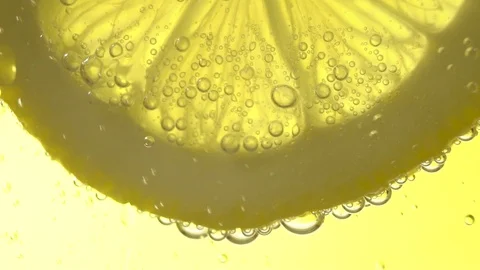 Slow Motion Macro shot of a lime slice in water bubbles 스톡 동영상 123368092