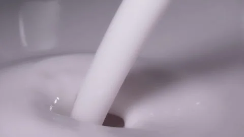 Slow motion, macro shot: Milk pouring into milk. UHD25p Stock Footage 249079579