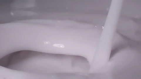 Slow motion, Macro shot: Milk pouring into milk. UHD25p Stock Footage 249079666