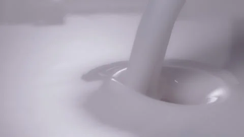 Slow motion, macro shot: Milk pouring into milk. UHD25p Stock Footage 249083273