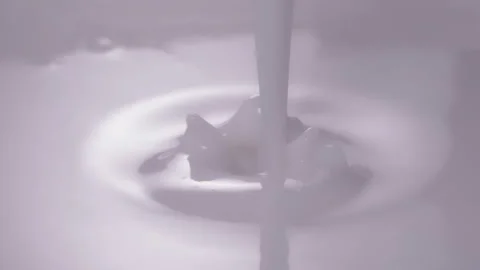 Slow motion, macro shot: Milk pouring into milk. UHD25p Stock Footage 249083666
