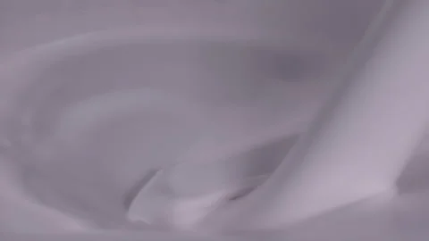 Slow motion, macro shot: Milk pouring into milk. UHD25p Stock Footage 249599745