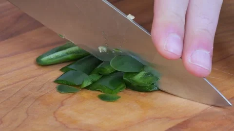 Slow Motion Macro Shot of Slicing a Green Chili Pepper on a Cutting Board Video stock 317771746