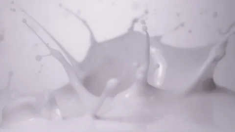 Slow motion, macro shot: Strawberries falling into milk. UHD25p Stock Footage 249587319