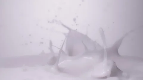 Slow motion, macro shot: Strawberries falling into milk. UHD25p Stock Footage 249587806