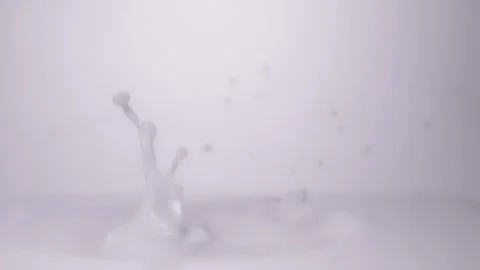 Slow motion, macro shot: Strawberry falling into milk. UHD25p Stock Footage 249586996