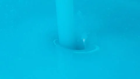 Slow motion macro shot of thick blue liquid laundry detergent pouring. Stock Footage 337561302